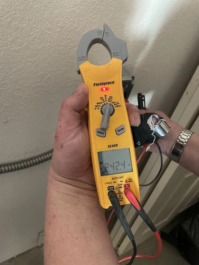 Voltage testing with clamp meter during Recessed Lighting Installation in Londonderry